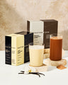 Factor Form protein packaging with two glasses of protein shakes on a neutral background